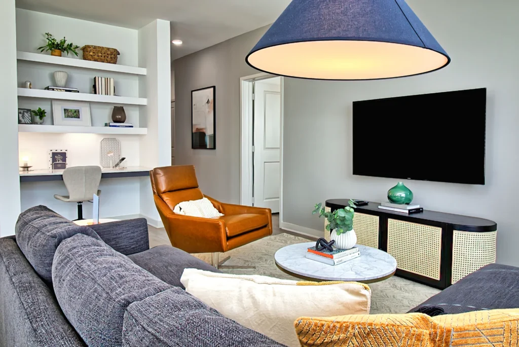 Interior photography of a cozy living room with a blue lamp, sofa, and warm seating area